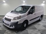 the white van is parked on a checkered floor in a room