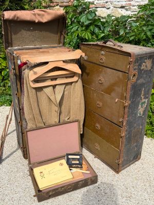 two old suitcases sitting next to each other on the ground