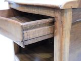 a wooden desk with a drawer on top of it