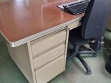 a computer desk with two monitors and a keyboard on it