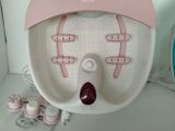 a pink and white electric foot spa machine on a counter