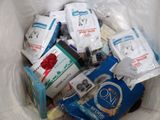 a white bag full of various items in it