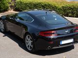 a black sports car parked in a parking lot