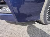 a close up of a car ' s front bumper and tire
