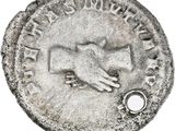 a close up of a coin with a hand on it