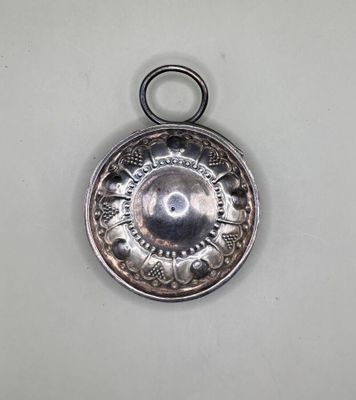 an antique silver plate with a circular design on it