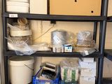 a black shelving with lots of boxes and containers on it