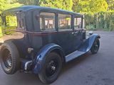 a vintage car parked on the side of the road