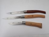 three different types of knifes with wooden handles on a white surface