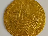 an image of a gold coin with a ship on it