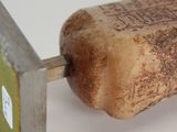 a wine cork with a knife stuck in it