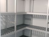 a very long shelf in the corner of a room