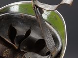 a metal bucket with a pair of scissors hanging from it