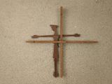 a cross made out of wooden sticks on the floor