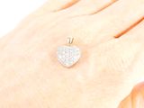 a woman ' s hand holding a heart shaped diamond ring