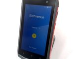 the cell phone is sitting on a stand with a blue screen