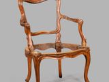 une image représentant une chaise en bois avec un dossier et des accoudoirs sculptés