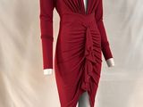 the mannequin is wearing a red dress with long sleeves