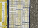 two michel michel timetables sitting on a carpeted floor next to each other