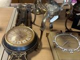 many different clocks on a table in a room