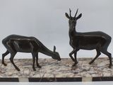 pair of black and white marble statues of deer and antelope on marble base