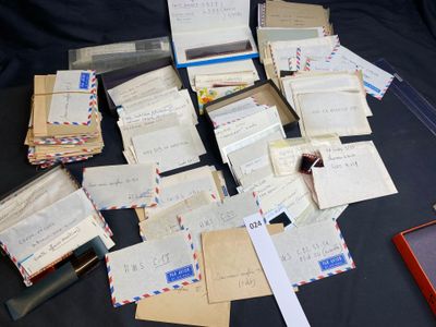 a pile of mail sitting on top of a table next to a cell phone