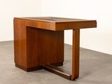 an image of a wooden table with a glass top on a concrete floor