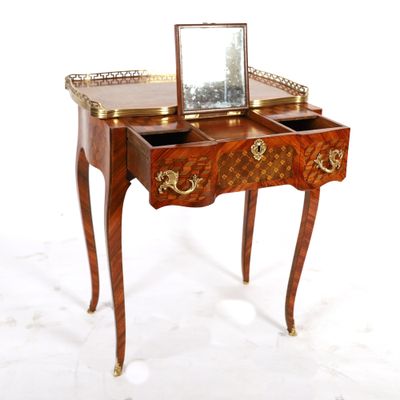 a small wooden table with a mirror on top of it