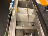 a sink that has a bunch of items in it