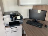 a desk with a computer and a printer on it