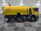 a large yellow truck that is parked in a room