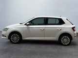 the white car is parked on the concrete floor in the room