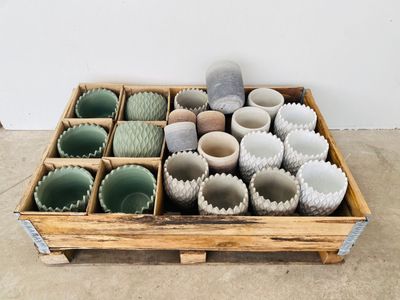 many cups in a wooden box on the floor