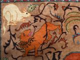 a close up of a rug with animals on it