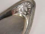 a silver plate with a decorative design on it
