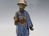 a small figurine of a man with a hat on