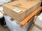 a large stack of boxes and pallets in a warehouse