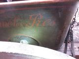 a large metal tub sitting on the ground with a chain around it