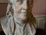 a bust of a man with long hair on a table