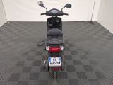 a motor scooter that is parked in a room