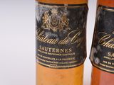 two bottles of wine sitting next to each other on a table