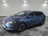 a blue car is parked on a checkered floor in a garage