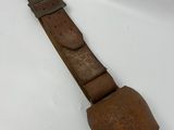 a close up of a brown leather watch strap on a white surface