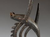 a close up of a sculpture of a bird on a stand