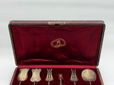 a set of silverware in a case with a red velvet lining