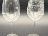 two wine glasses sitting next to each other on a table