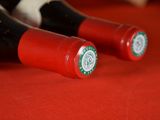 two bottles of wine sitting on a red table