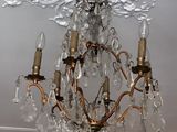 a crystal chandelier hanging from the ceiling in a room