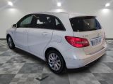 the back of a white mercedes b - class parked on a checkered floor