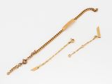 a close up of a gold bracelet and a gold chain